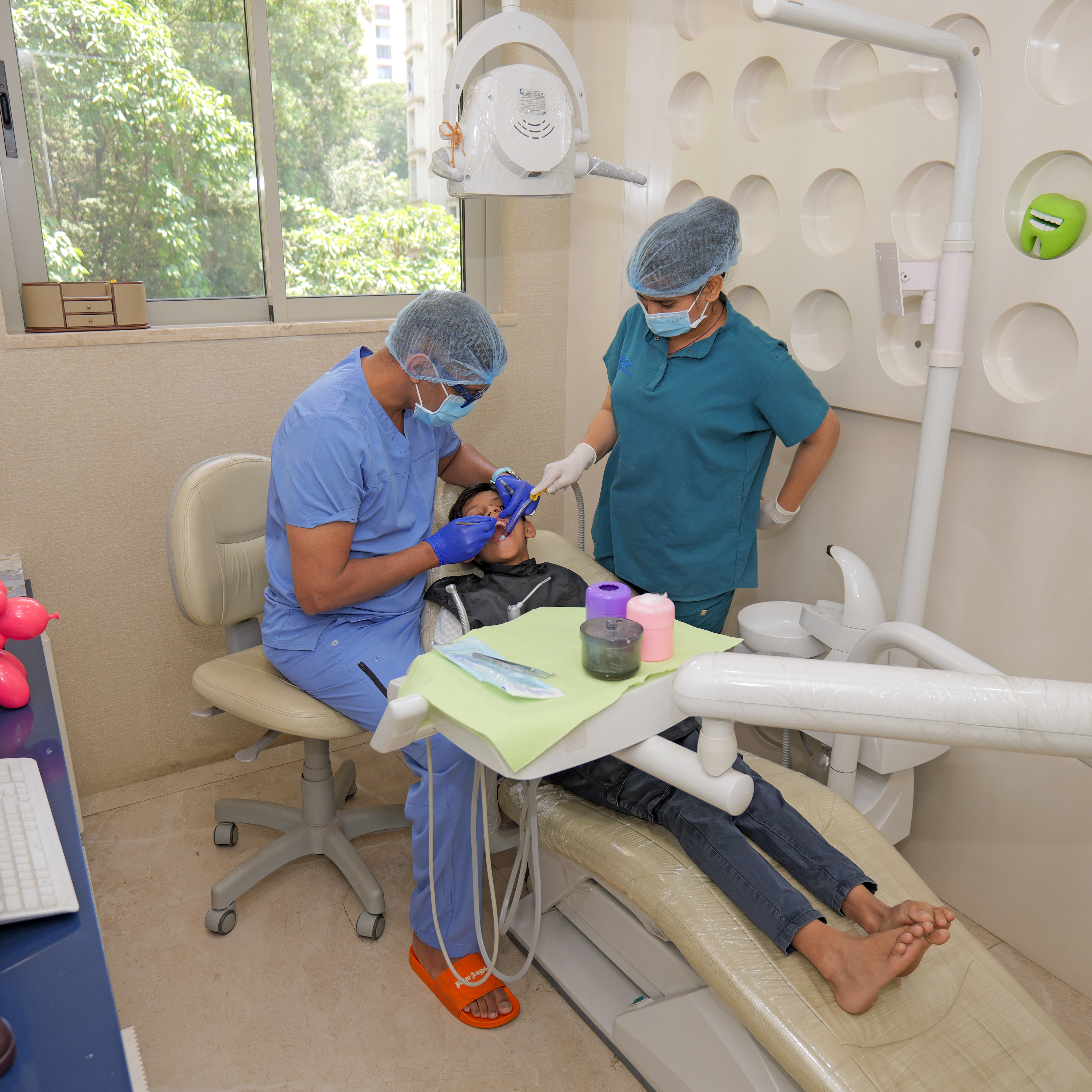 Dr Nishant dental surgeon in Powai Mumbai examining and treating patient during consultation